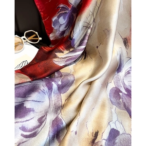 Close-up of elegant floral silk scarf with satin luster and smooth hem detail