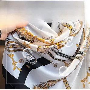 Detail showing soft imitation silk fabric with elegant black and gold paisley patterns