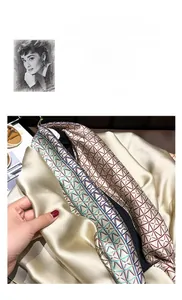 Detail of silk-like satin scarf with red and blue geometric chain link patterns