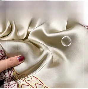 Detail of silk satin scarf showing champagne gloss and vintage geometric edge patterns