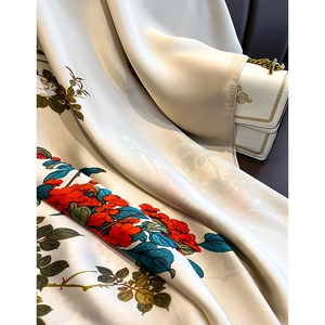 Elegant ivory silk scarf with red camellia floral print and smooth glossy texture
