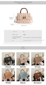 Detail view of ruched cloud bag with bamboo handle and patterned crossbody strap specs