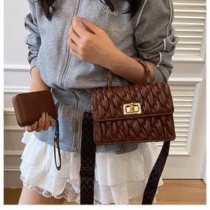Detail of quilted brown handbag with bamboo handle and matching mini coin purse
