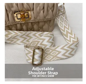 Detail of bamboo twist lock and geometric woven adjustable strap on quilted beige bag