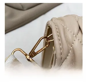Detail of high-quality golden zinc alloy hook and quilted leather texture on a bag