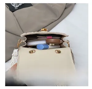 Detailed interior of beige quilted bag with bamboo turn-lock and spacious storage