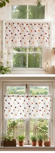 Detail of white cafe curtain with embroidered dots and decorative fringe tassels