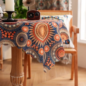 Detail of bohemian mandala tablecloth with scalloped edges and ethnic floral pattern