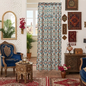 Ethnic bohemian door curtain with geometric floral patterns in a cozy room setting