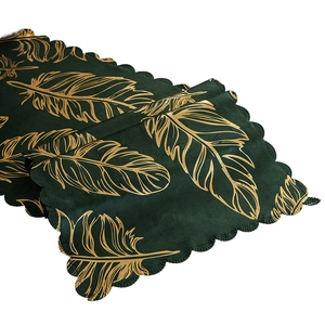 Dark green velvet table runner with gold feather patterns and wavy scalloped edges