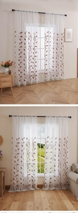 Detail of white semi-sheer curtain with reddish-brown wheat embroidery and wavy edges