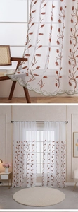 Detail of white semi-sheer tulle curtain with wheat embroidery and green scalloped edges