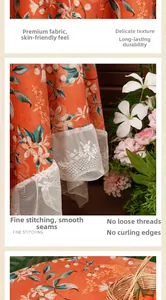 Macro detail of orange floral tablecloth fabric featuring exquisite white lace trim edge