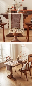 Close-up of woven table runner featuring brown and beige textures with handmade tassels