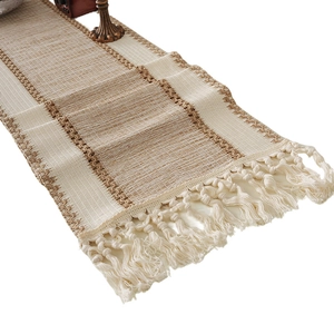 Bohemian style woven table runner with tassels and natural beige stripes on white background