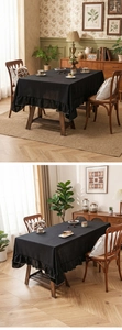Detail of elegant black linen rectangular tablecloth with ruffled edges for home decor
