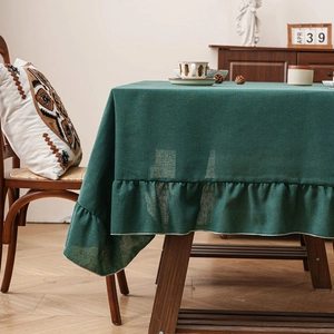 Dark green rectangle linen tablecloth with elegant ruffled edges for farmhouse decor