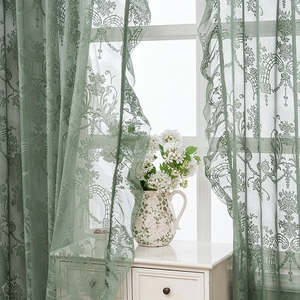 French retro light green lace curtain with elegant European floral patterns in a room