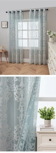 Detail of light blue damask sheer curtains with white floral embroidery and metal grommets