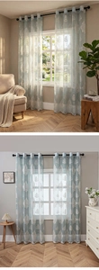 Detail of light blue damascus sheer curtain with metal eyelets in a bright living room