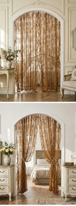 Detail of French vintage lace curtain with golden floral embroidery and scalloped edges