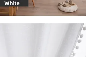 Close-up of white linen texture sheer curtain featuring decorative pom-pom fringe details