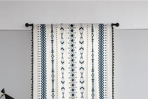 Detail of bohemian printed cotton linen curtain with geometric patterns and black tassels