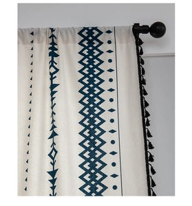 Close-up of geometric pattern on cotton linen curtains with black tassel trim details