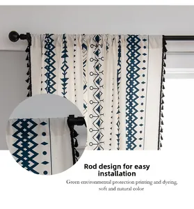 Detail of bohemian cotton linen curtain with blue geometric prints and black tassels