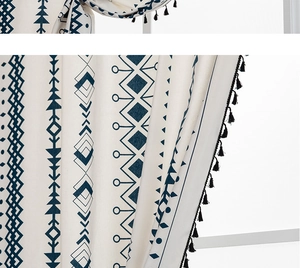 Detail of bohemian cotton linen curtain with navy geometric prints and black tassels