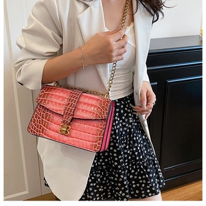 Pink croc-embossed square bag with golden butterfly lock and chain strap detail
