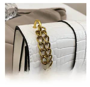 Close-up of white crocodile pattern PU leather bag with premium gold chain strap