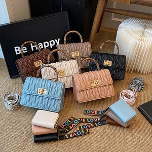 Chic quilted handbag with bamboo handle and woven strap in multiple color options