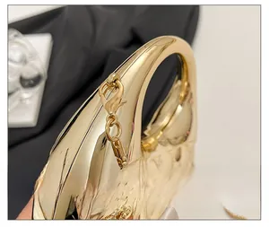Makroaufnahme der polierten Goldoberfläche und hochwertigen Metallbeschläge dieser kleinen Tasche