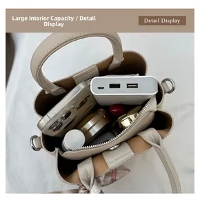 Interior view showing the large capacity of the beige pebble leather bucket bag