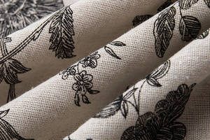 Detailed macro texture of American floral linen curtain fabric with vintage plant print