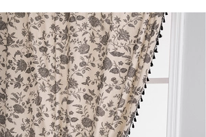 Detail of American floral print curtain with cotton linen texture and black fringe trim