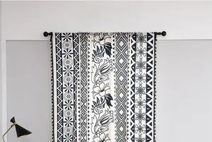 Detail of geometric ethnic print curtain with black tassel fringe and rod hanging