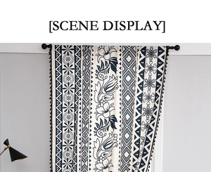 Detail of bohemian printed curtain featuring black pom pom tassels and geometric floral pattern