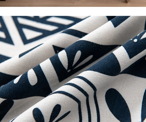 Close-up of cotton linen fabric texture with ethnic blue and white floral pattern