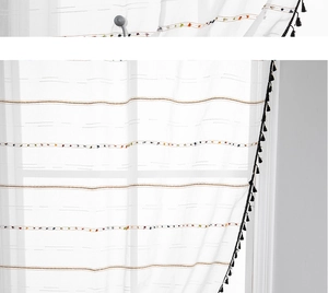 Close-up of white semi-sheer curtain with coffee stripes, tassels and magnetic ball tieback