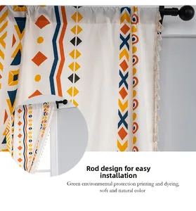 Detail of bohemian geometric print curtain with rod pocket and beige tassels edge