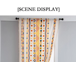 Detail of bohemian cotton linen curtain with geometric patterns and beige fringe tassels