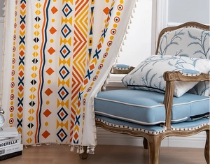 Detail of bohemian cotton linen curtain with geometric patterns and white tassels