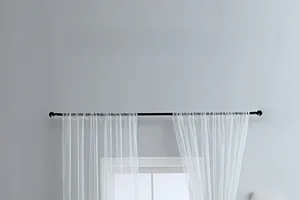 Detail view of white embroidered sheer curtain with minimalist floral texture and patterns