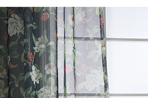 Detailed close-up of floral print semi-sheer linen fabric with white flowers and green leaves