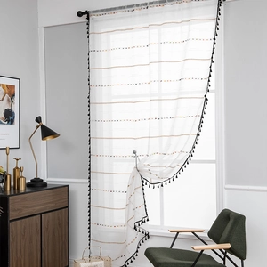 White sheer curtain with black tassel trim and geometric striped texture for windows