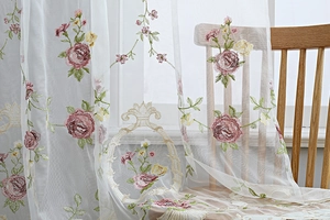 Detailed embroidery on white sheer curtain with pink roses and green leaves pattern