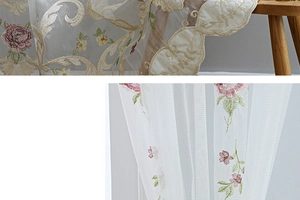 Close-up of white lace curtain with pink rose embroidery and wavy scalloped edges