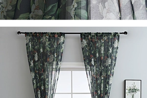 Detailed view of floral print on semi-sheer black voile curtains with rod pocket style